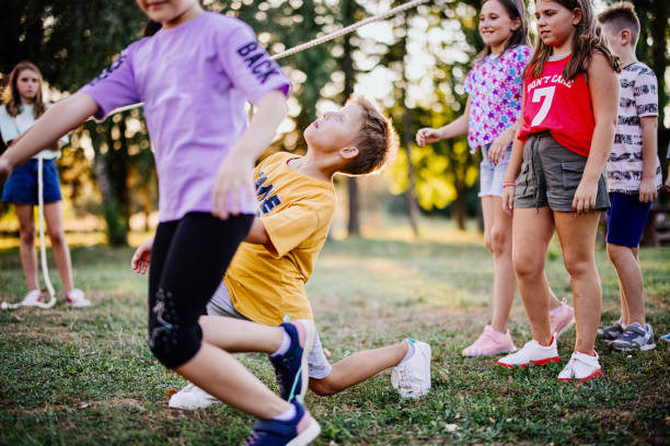 istock Elementary school kids dancing limbo at summer camp 1370083376