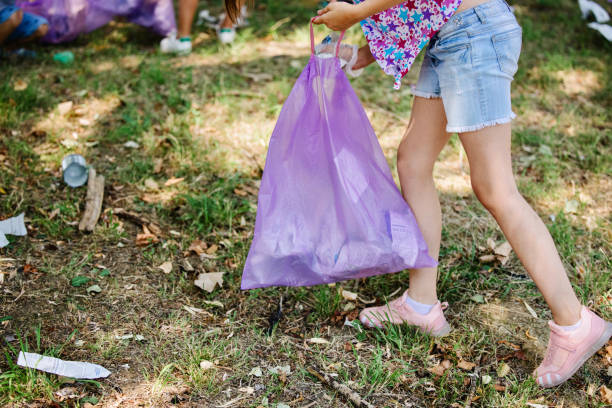istock Kids cleaning up the park from garbage 1370084207