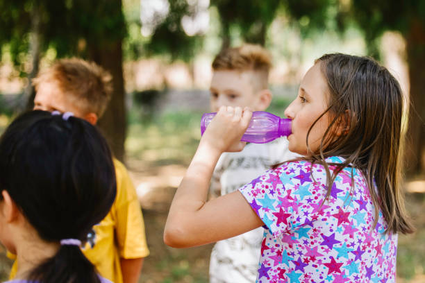 istock Kids cleaning up the park from garbage 1370084238