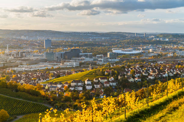 Germany, Stuttgart city  skyline panorama landscape view above industry, houses, streets, arena in basin at sunset stock photo