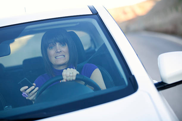 istock Woman driving holding a cellphone 137008930