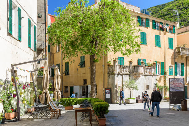Finalborgo. Finale Ligure, Italy. Finalborgo. Finale Ligure, Italy. May 5, 2021. View of Via Lancellotto with outdoor tables of a restaurant. finale ligure stock pictures, royalty-free photos & images