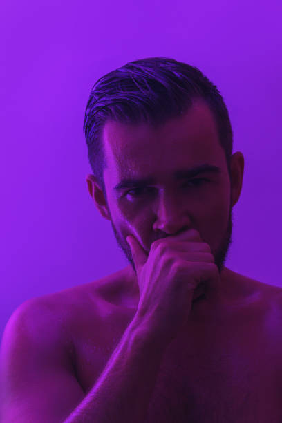 istock Handsome young man with wet skin in ultraviolet light 1370095724
