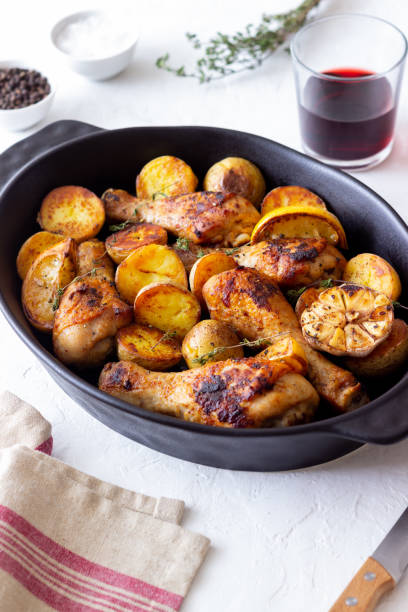 istock Baked chicken legs with potatoes and lemon. Recipe. 1370098220