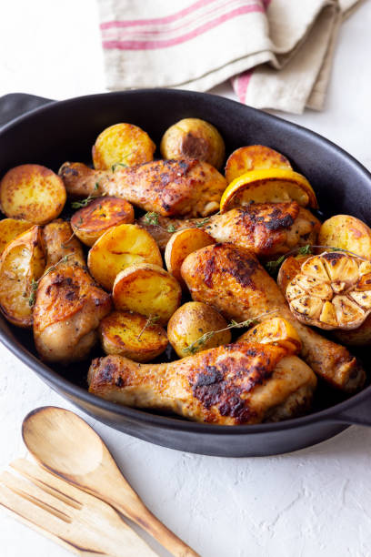 istock Baked chicken legs with potatoes and lemon. Recipe. 1370098233