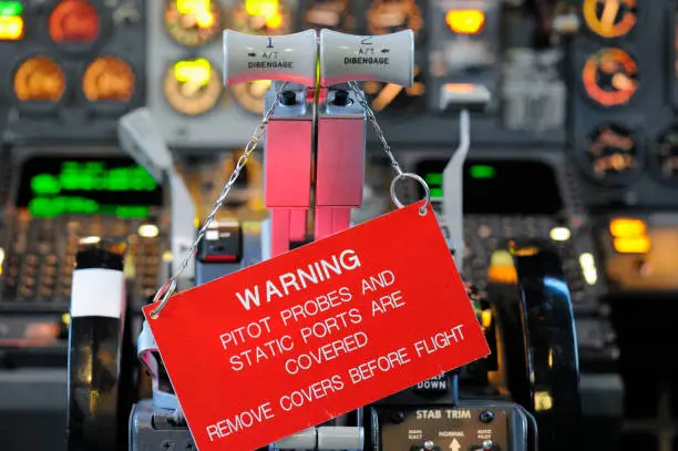 A sign is attached to B737-300 thrust levers to prevent flight operations with probe and port covers attached