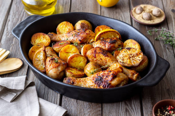 istock Baked chicken legs with potatoes and lemon. Recipe. 1370098436