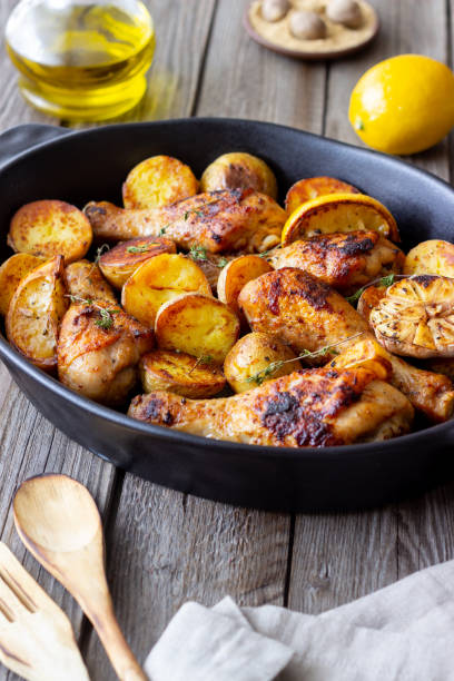 istock Baked chicken legs with potatoes and lemon. Recipe. 1370098445