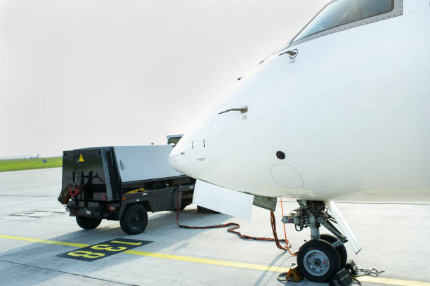 istock Ground Power Unit Attached to Passenger Jet Parked on Apron 1370098472