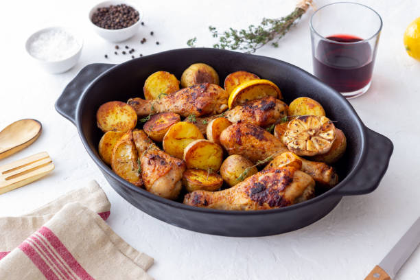 istock Baked chicken legs with potatoes and lemon. Recipe. 1370098633