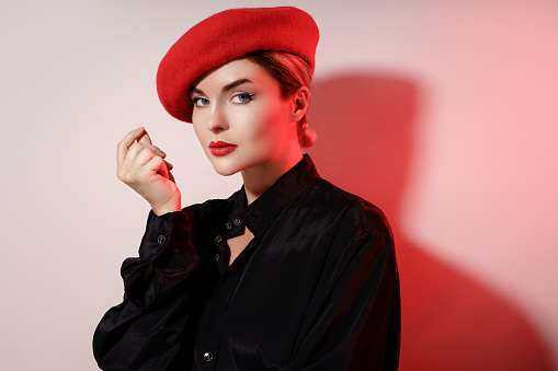 Fashion portrait of young beautiful woman wearing red beret