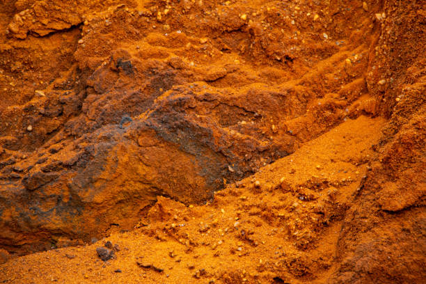 istock Textural sand, with  relief surface, multi-colored layers and different in size of granules, in outdoor sand career, after mining ore and sand for construction. 1370101106
