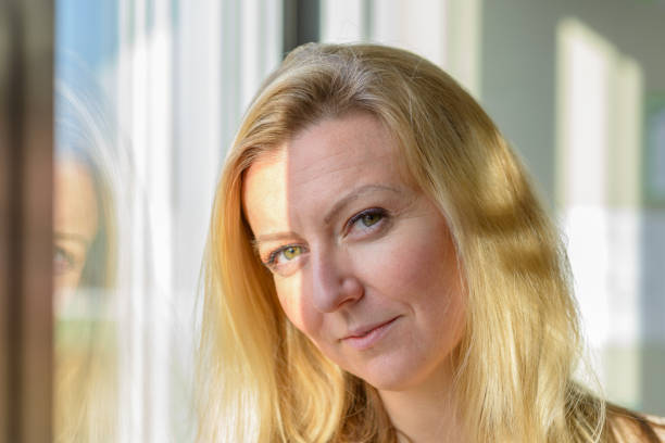 istock Attractive blond woman standing daydreaming 1370101126