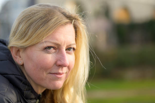 istock Attractive friendly blond woman in town 1370101173
