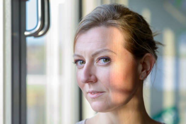 istock Quizzical blond woman with a knowing smile 1370101182