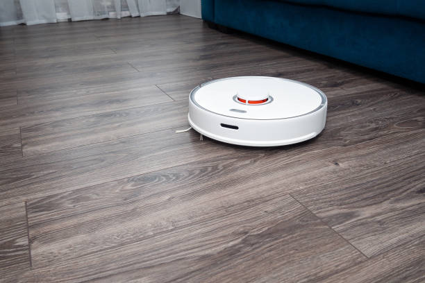 istock a white vacuum cleaner robot on a laminated wooden floor. 1370101646