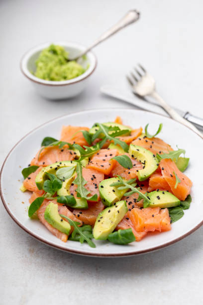 istock Fresh salmon salad with avocado,  for keto and low carb diet. Rusty background, top view, copy space. 1370102276