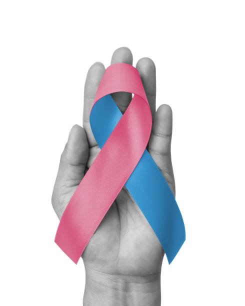 pink blue ribbon awareness for birth defects month, (sids) infertility, miscarriage, infant loss, amniotic fluid embolism, male breast cancer, bow isolated on white background (clipping path) on hand - bronquiolite imagens e fotografias de stock