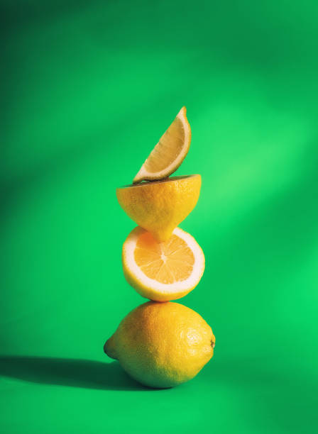 istock A stack of lemons, on a green background, vertical, no people, food background, 1370103615