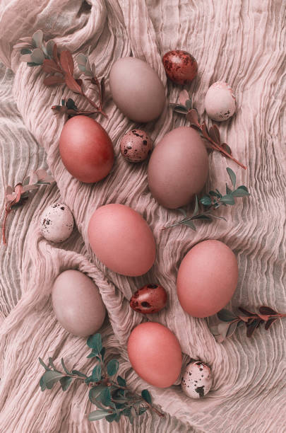 istock Easter eggs , coral tone, on beige fabric, top view, vertical, no people, Easter card, 1370103616