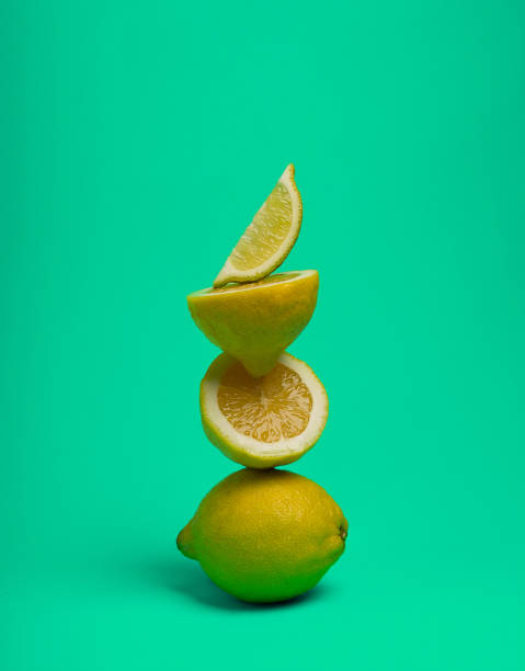 istock A stack of lemons, on a green background, vertical, no people, food background, 1370103810