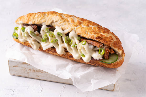 Baguette Asian fusion vegan sandwich with fermented and fresh vegetables Baguette Asian fusion vegan sandwich with fermented and fresh vegetables on textured white mayonnaise stock pictures, royalty-free photos & images