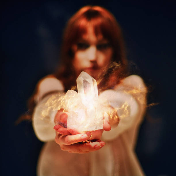 istock Woman's hand with a healing crystal. 1370107272