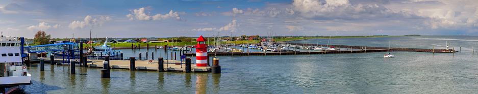 Vista del paisaje costero con entrada de puerto y puerto deportivo en Wyk auf Föhr desde un ferry. Luz roja del muelle en el puerto de Wyk auf Föhr. Isla del Mar del Norte en Frisia del Norte, Schleswig-Holstein. photo