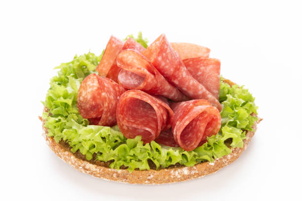 istock Sandwich with salami sausage on white background. 1370108385