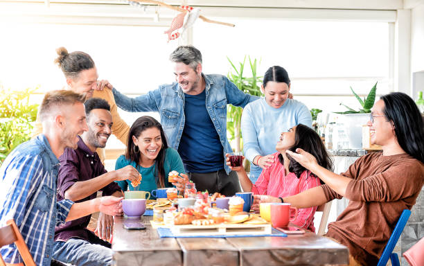 istock Young friends doing breakfast in bar bakery shop before going to school - People talking and having fun together at fashion cafeteria - Friendship concept with happy men and women at cafe drink coffee 1370109972