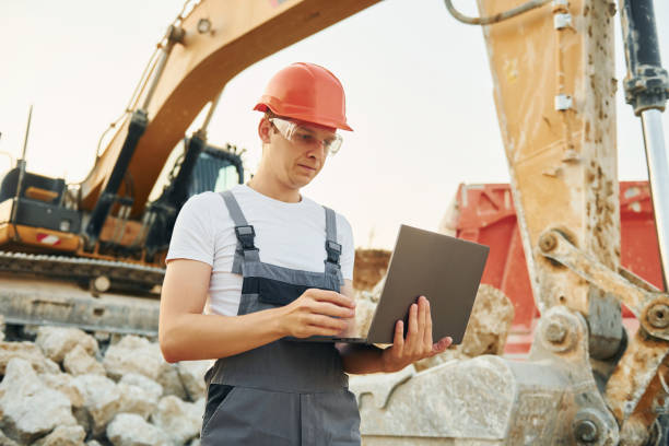 istock Busy day. Worker in professional uniform is on the borrow pit 1370110582