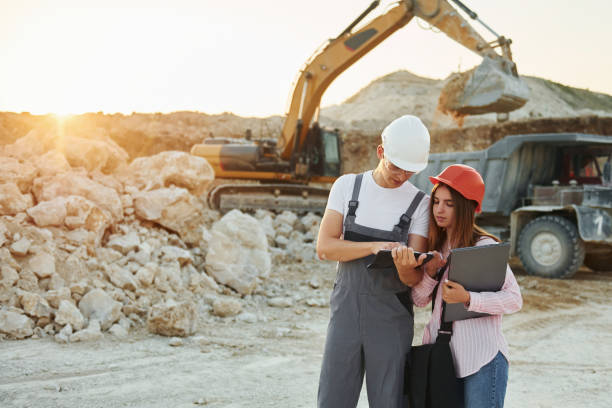 istock With documents. Two workers is on the borrow pit at daytime together 1370111796