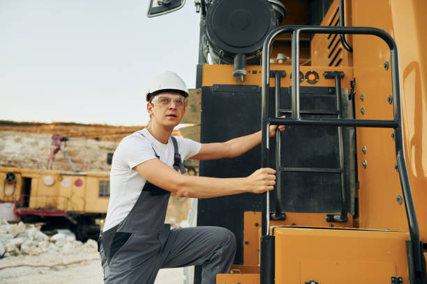 istock Quality vehicle. Worker in professional uniform is on the borrow pit at daytime 1370112961