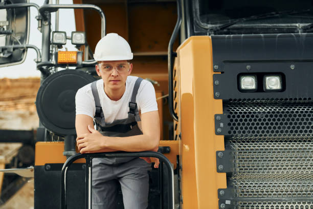 istock On the vehicle. Worker in professional uniform is on the borrow pit at daytime 1370113081
