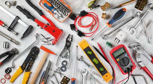 Set of hand tools on white plaster background. Work tools for electrician, carpenter, mechanic, plumber and hobist. Top view, flat lay. Handicraft and industrial tools, group of objects. electrician multimeter stock pictures, royalty-free photos & images