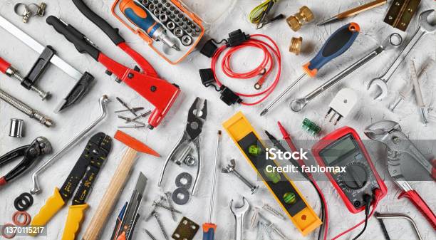 Set Of Hand Tools On White Plaster Background Work Tools For Electrician Carpenter Mechanic Plumber And Hobist Top View Flat Lay Stock Photo - Download Image Now