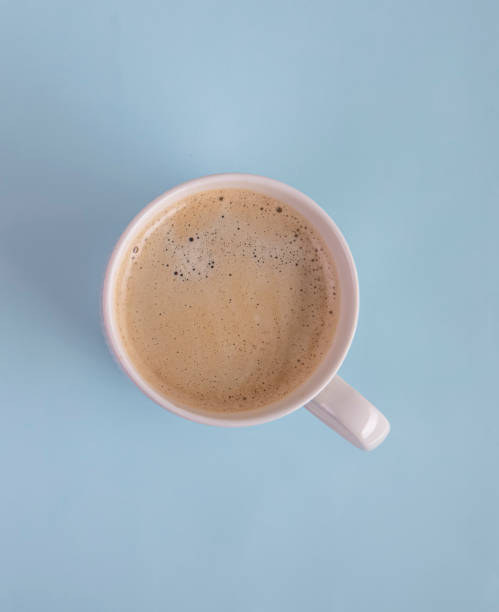 istock Cup of coffee on blue background 1370115553