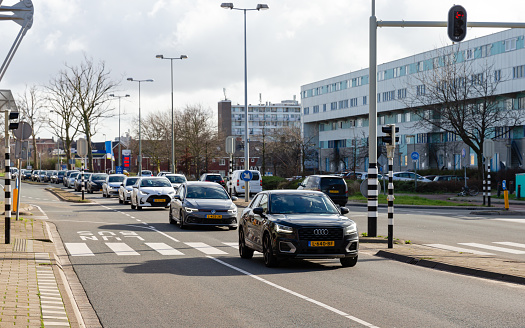 Schiedam, South-Holland, Netherlands, february 5th 2022, a black Dutch 2017 Audi Q2 station wagon and other cars approaching in line on the \