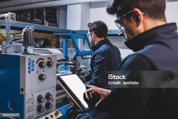 Mechanical Technicians Operative Of Cnc Milling Cutting Machine Center At Tool Workshop Stock Photo - Download Image Now