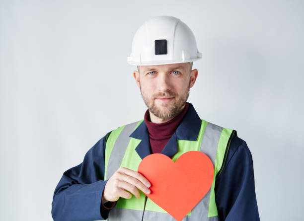 istock Valentine's Day concept: male worker showing red heart 1370124786