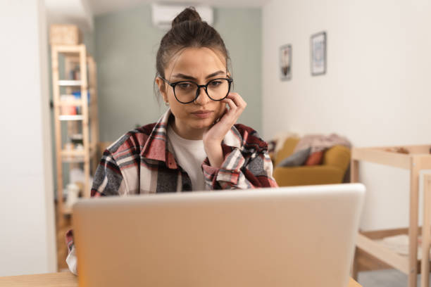 istock Young woman working online from her home office 1370125449