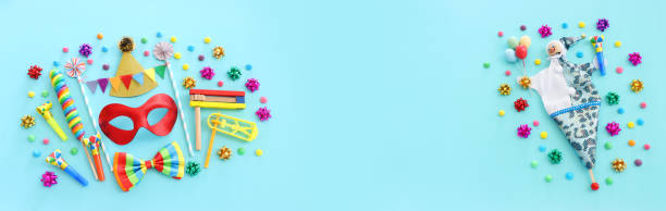 Purim celebration concept (jewish carnival holiday) over blue background