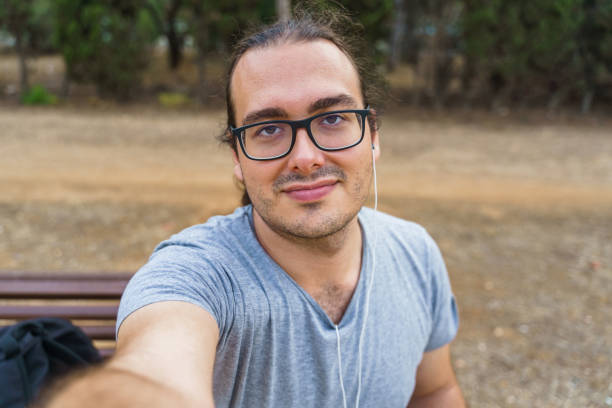 istock Smiling man taking a selfie with his smartphone 1370128663