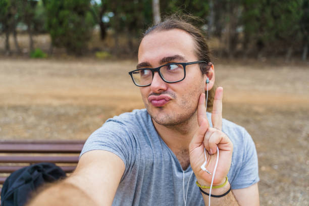 istock Man taking a selfie with his smartphone and pouting 1370128713