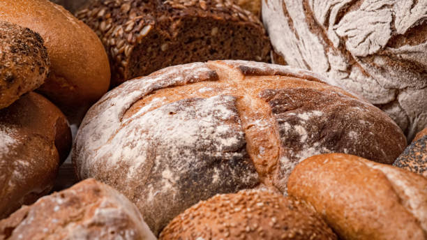 istock Freshly baked natural bread is on the kitchen table. 1370128755