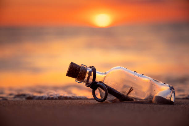 istock Message in the bottle against the Sun setting down 1370128815