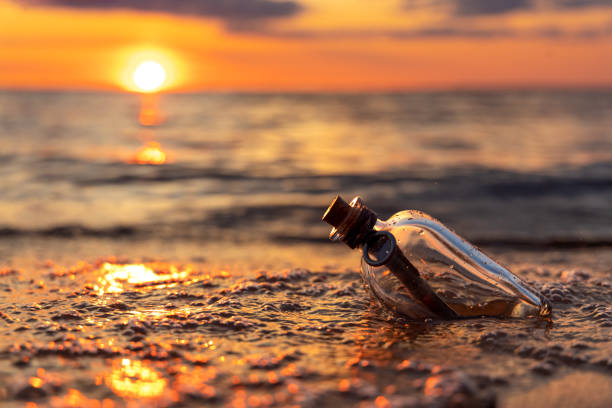 istock Message in the bottle against the Sun setting down 1370128821