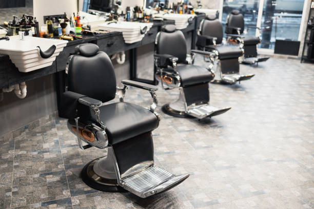 istock Row of empty chairs in a barbershop 1370130246