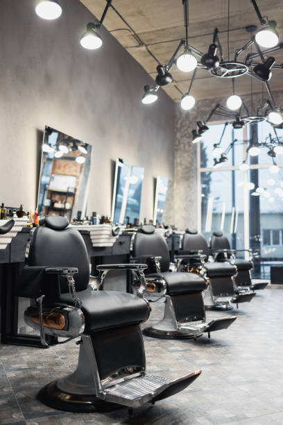 istock Row of empty chairs in a barbershop 1370130279