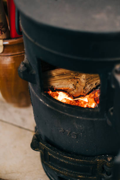 istock Black vintage fireplace with wood inside, close up. 1370132878